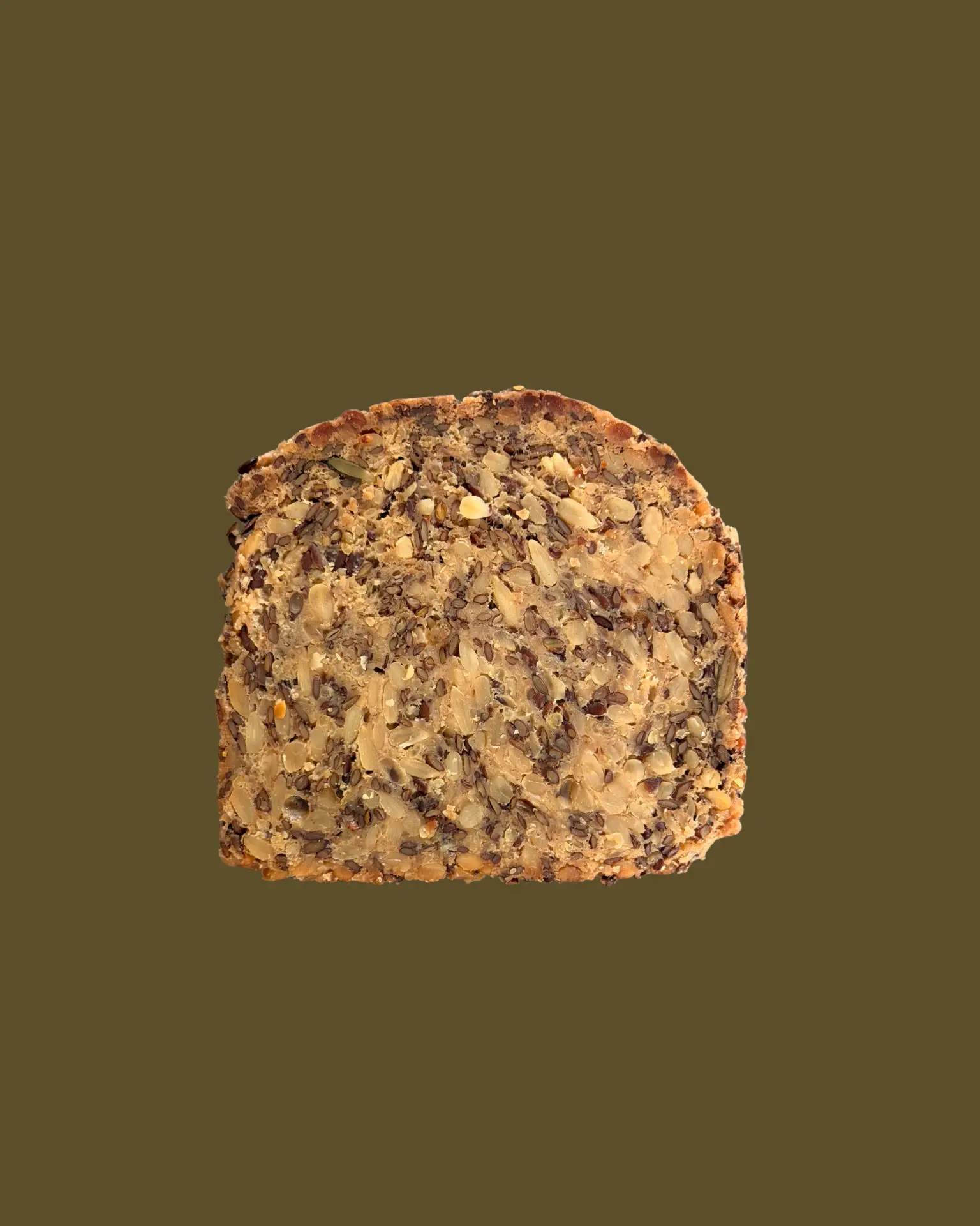 A single slice of dense seed bread on roasted olive